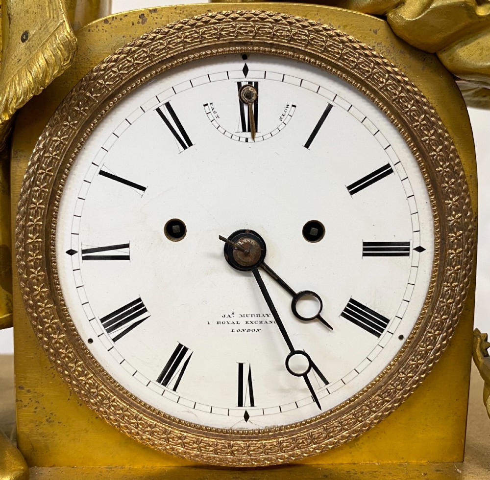 A nineteenth-century gilt bronze figural mantel clock depicting a seated artist and companion figure above a white enamel dial with Roman numerals. View III