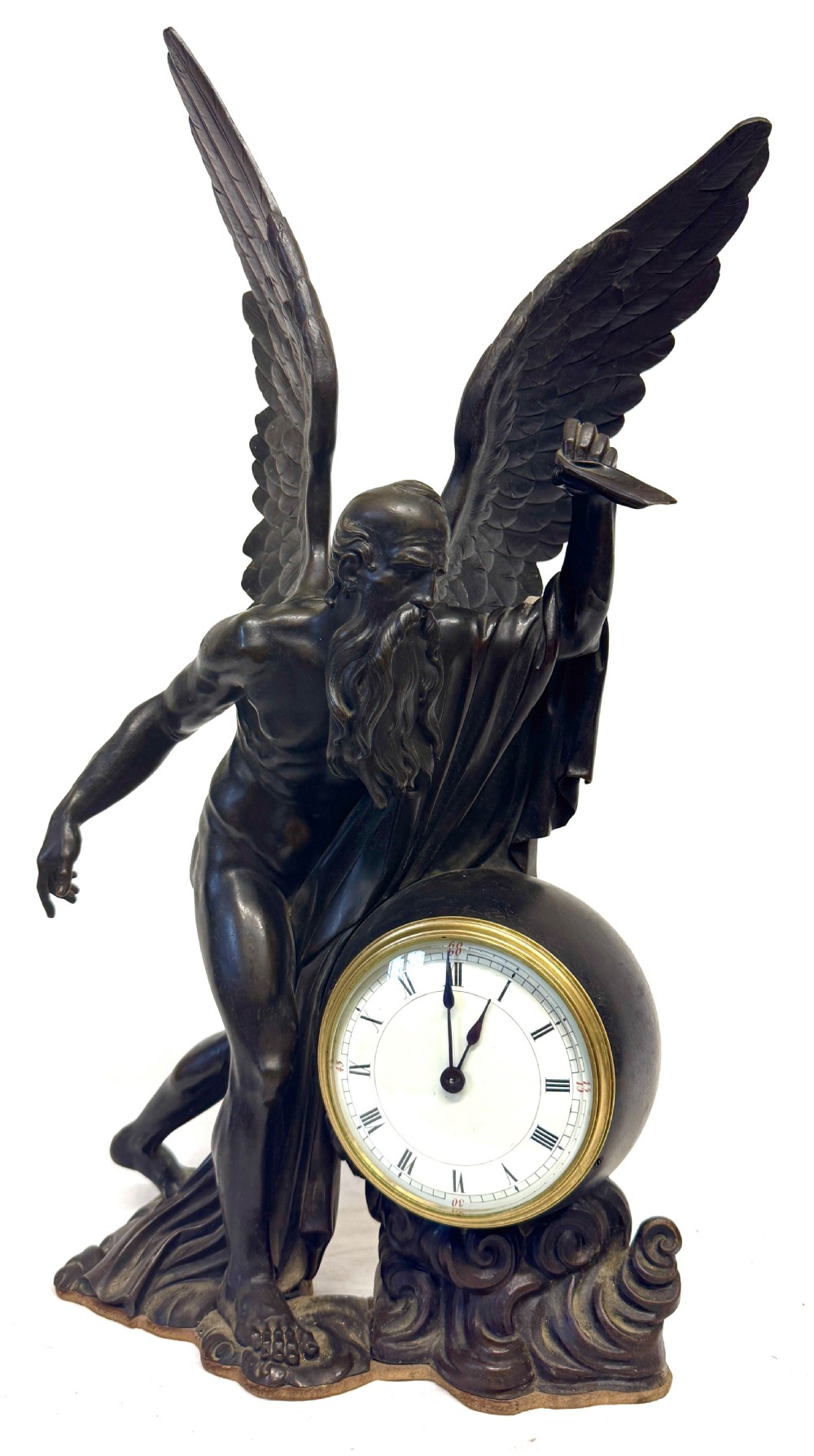 A dark bronze sculptural mantel clock featuring a winged figure of Father Time holding a scythe alongside a round clock face with Roman numerals.