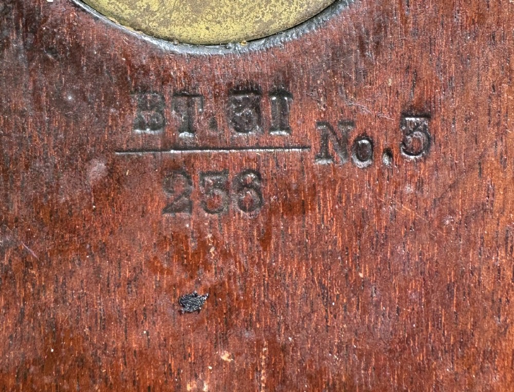 A circular antique mahogany wall clock with a brass bezel and an off-white dial marked with Roman numerals and the GPO stamp. View XIII