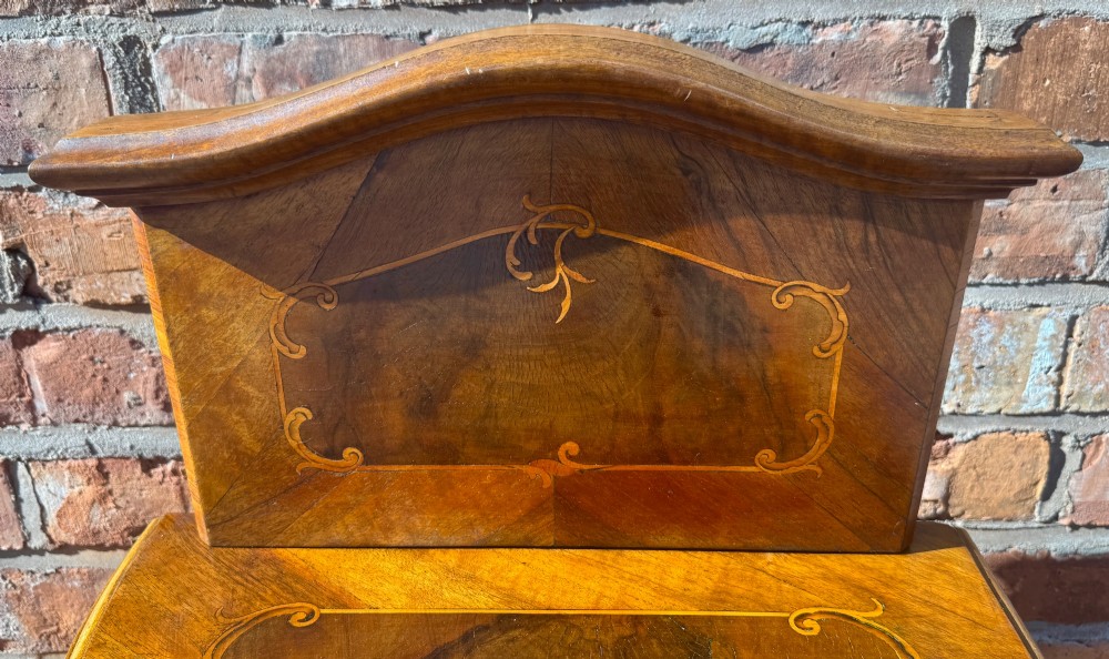 A pair of antique inlaid satinwood bedside cabinets featuring curved sides, decorative marquetry, shaped top galleries, and single doors with ornate brass handles. View VI