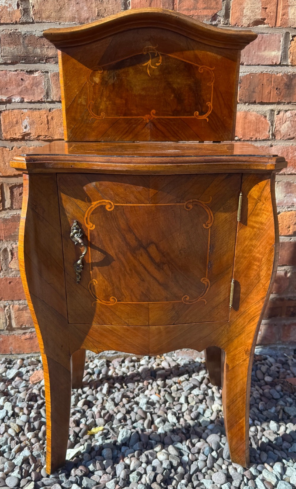 A pair of antique inlaid satinwood bedside cabinets featuring curved sides, decorative marquetry, shaped top galleries, and single doors with ornate brass handles. View XI