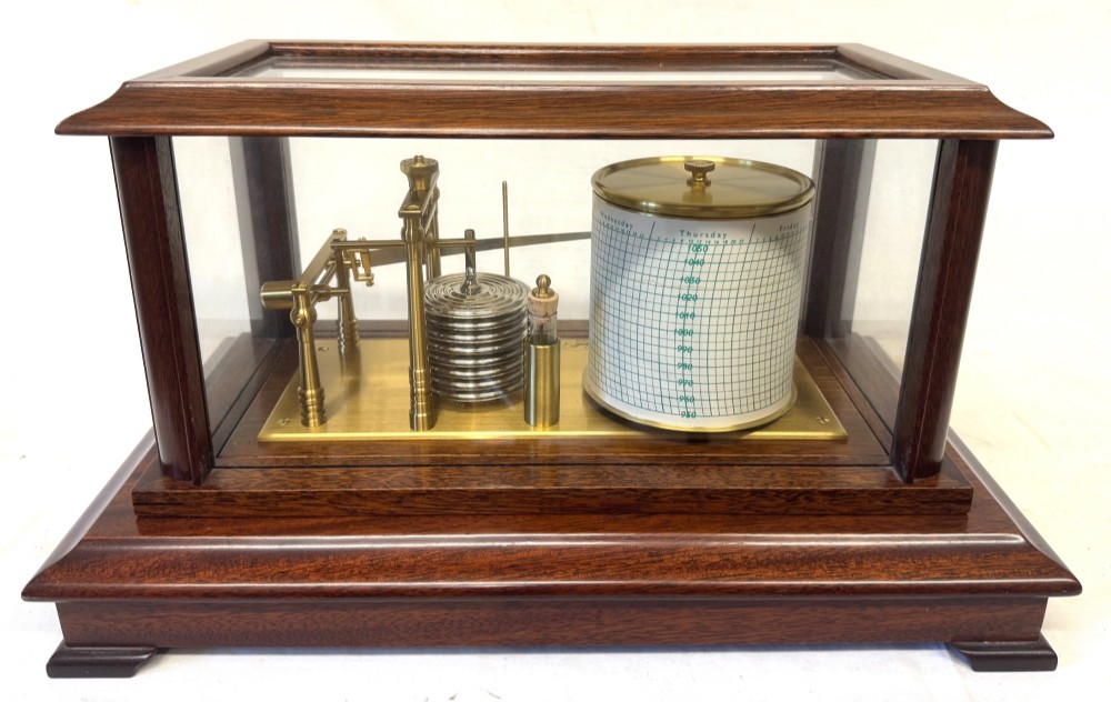 An antique mahogany and brass barograph housed inside a rectangular glazed display case with an internal paper chart drum. View V