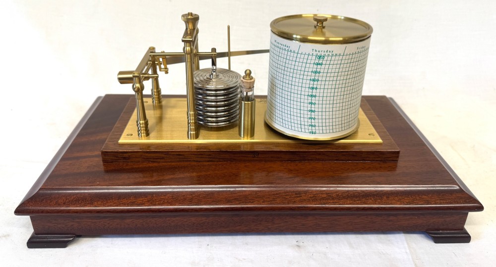 An antique mahogany and brass barograph housed inside a rectangular glazed display case with an internal paper chart drum. View X
