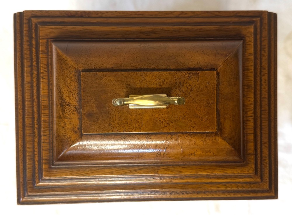 A burr walnut basket top mantel clock featuring an etched brass dial with Roman numerals, corner spandrels, side glass panels, and a top brass handle. View XI