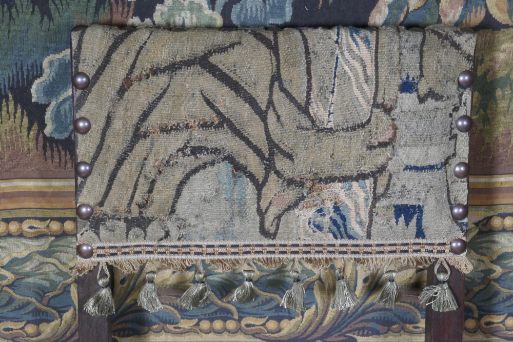 A pair of 17th-century oak back stools upholstered in tapestry fabric with tassel trim and turned legs. View II