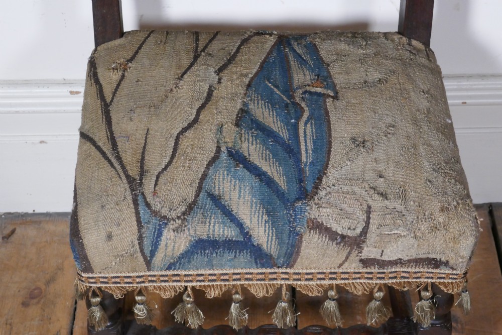 A pair of 17th-century oak back stools upholstered in tapestry fabric with tassel trim and turned legs. View III