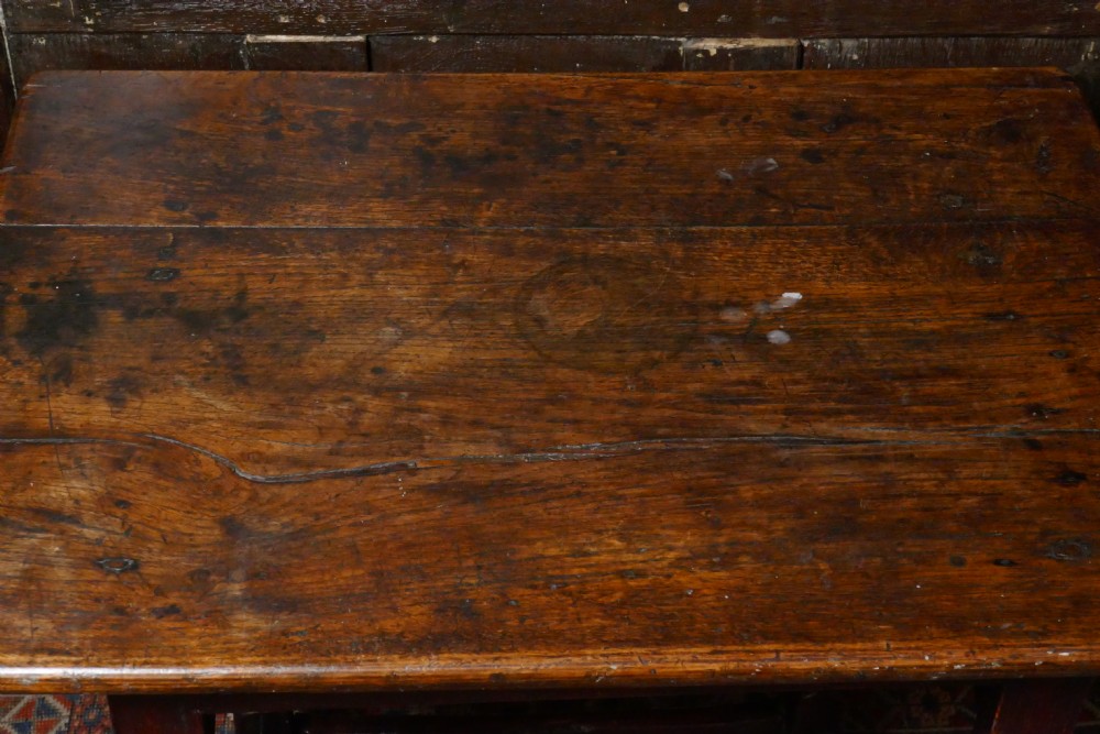 A 17th-century dark oak side table featuring a rectangular plank top, turned legs, and square perimeter stretchers. View III