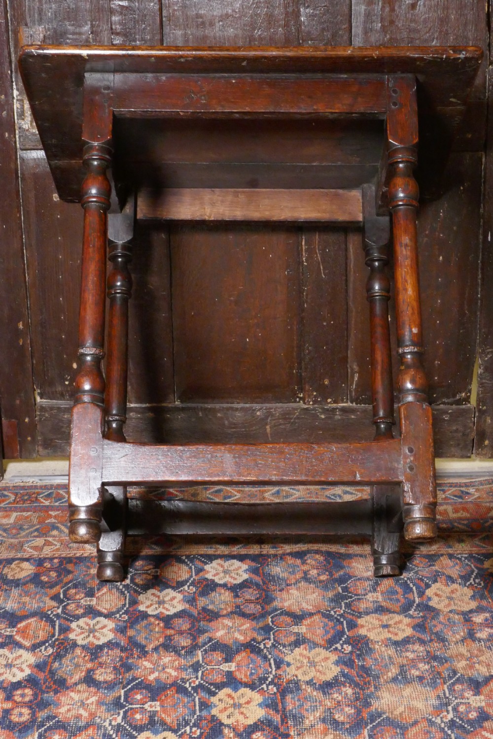 A 17th-century dark oak side table featuring a rectangular plank top, turned legs, and square perimeter stretchers. View X