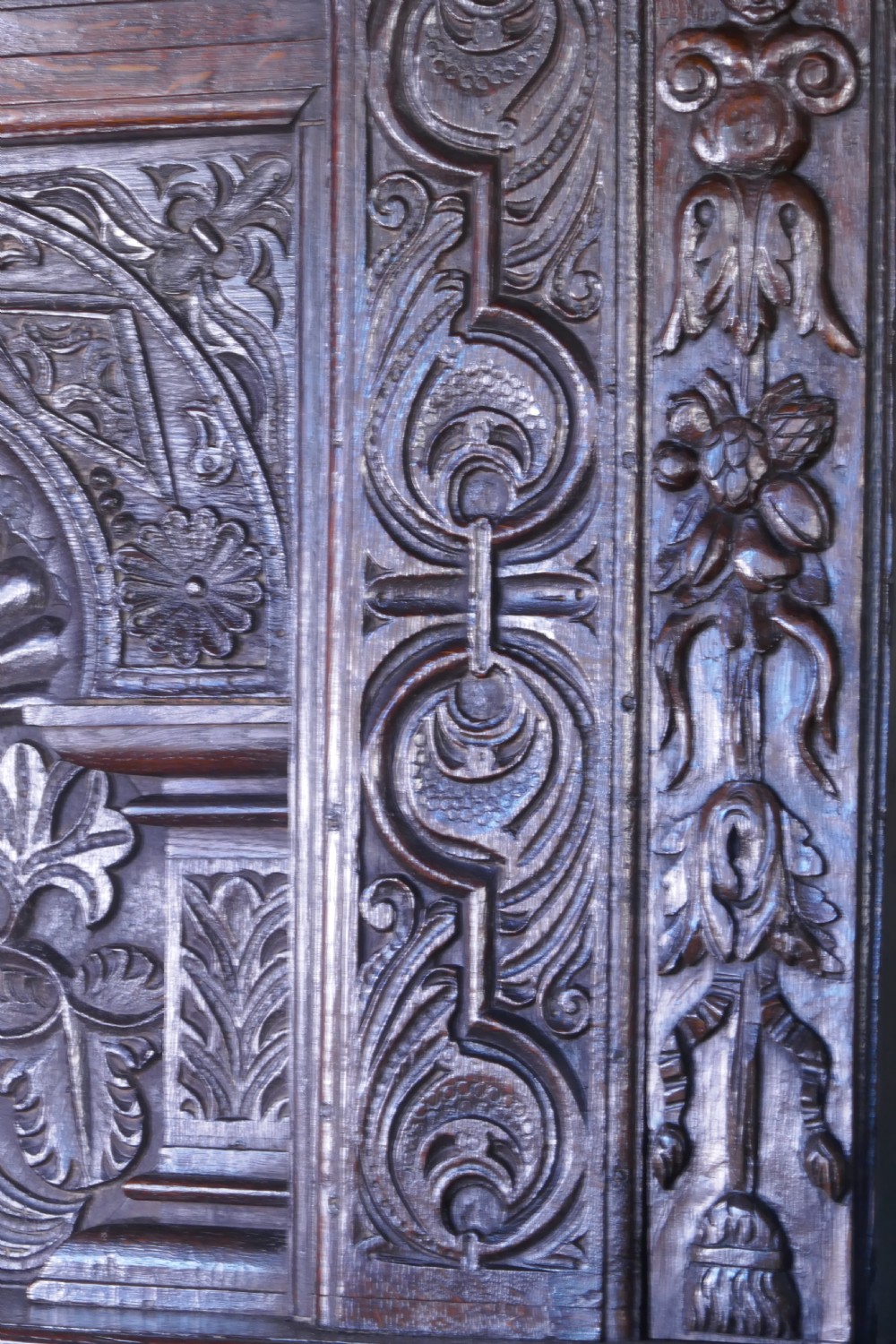 A dark oak 17th-century full tester bed featuring a relief-carved headboard, turned front posts, and a coffered ceiling canopy. View VIII