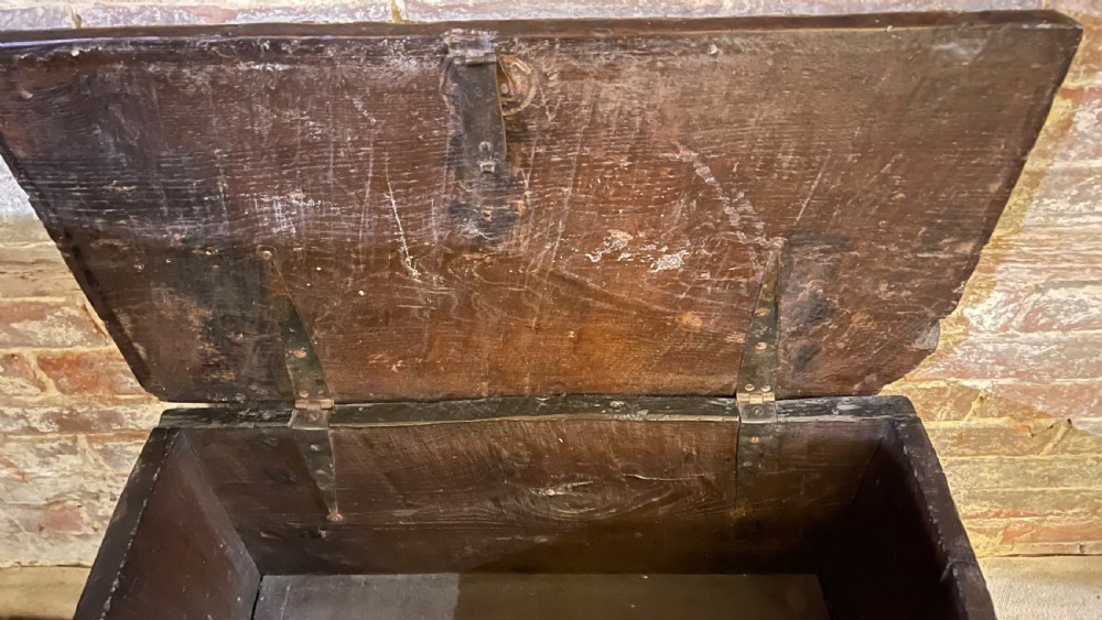A dark oak 16th-century coffer featuring geometric star marquetry inlay within diamond panels and a hand-forged iron lockplate. View IX