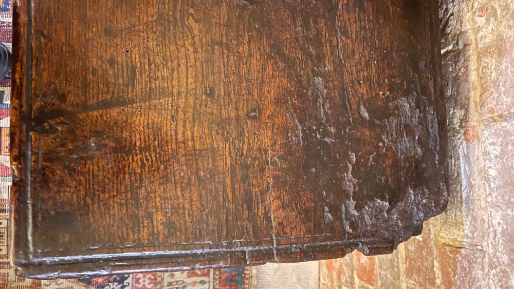 A dark oak 16th-century coffer featuring geometric star marquetry inlay within diamond panels and a hand-forged iron lockplate. View XI