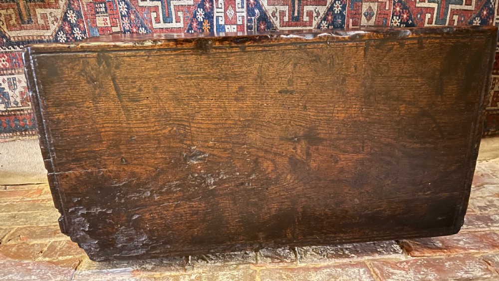 A dark oak 16th-century coffer featuring geometric star marquetry inlay within diamond panels and a hand-forged iron lockplate. View XII