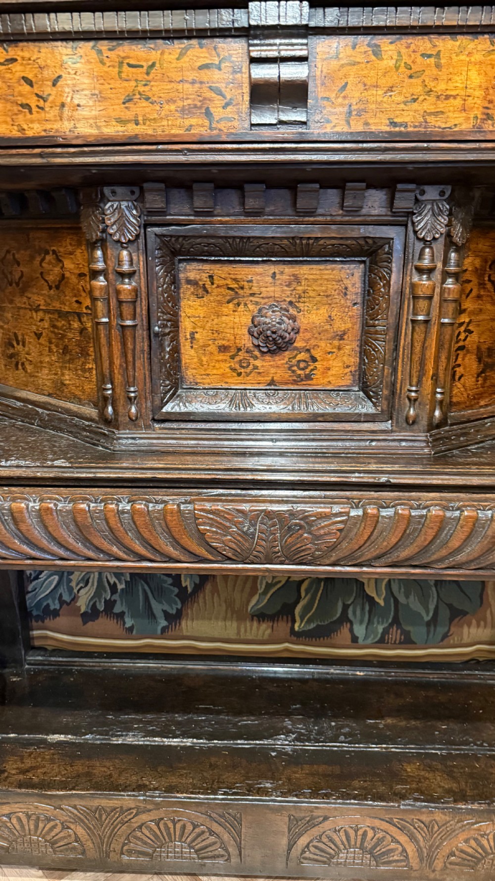 A 17th-century carved oak livery cupboard featuring inlaid wooden panels, carved lion supports, and bulbous turned legs. View IV
