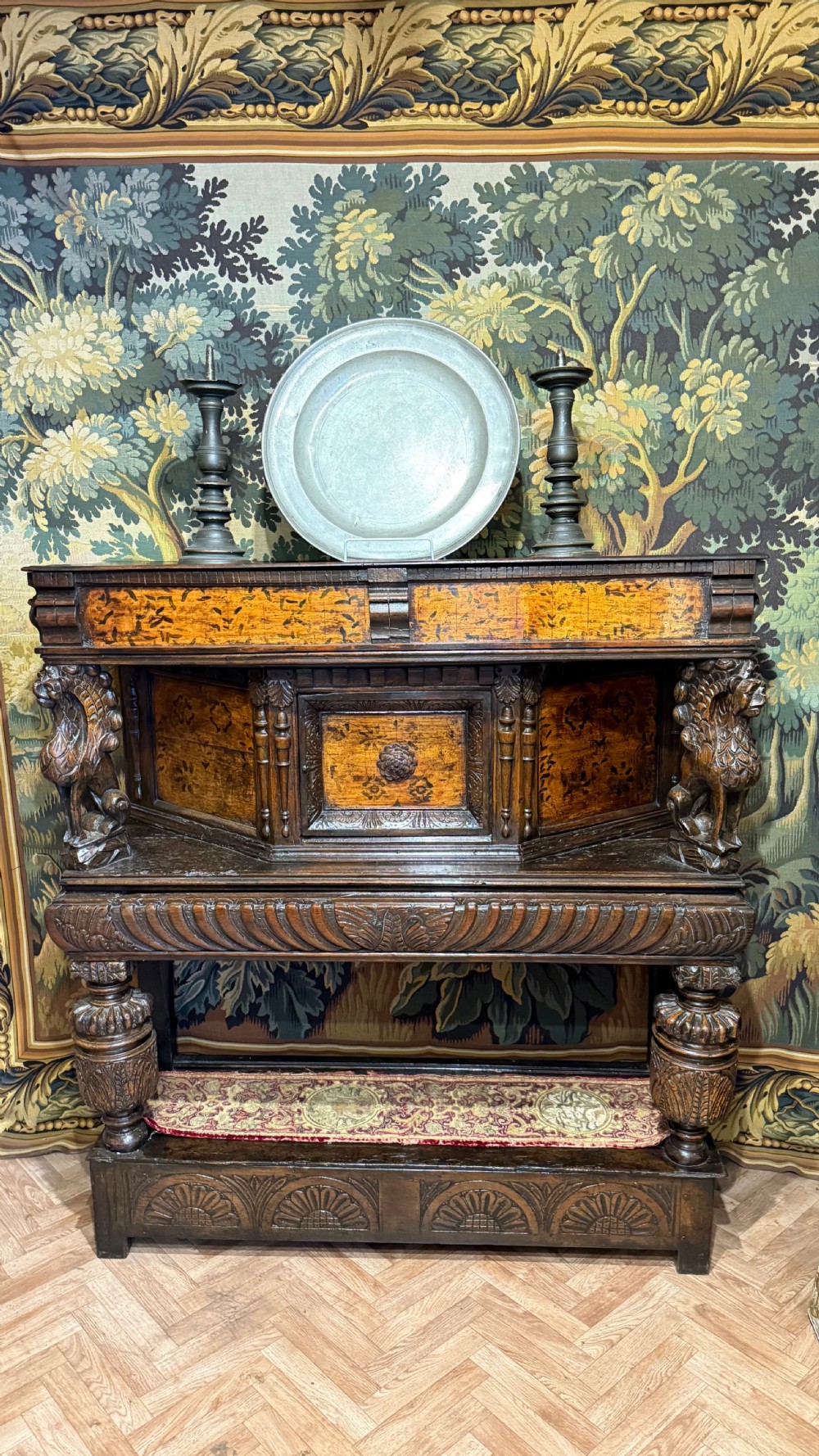 A 17th-century carved oak livery cupboard featuring inlaid wooden panels, carved lion supports, and bulbous turned legs. View XIV