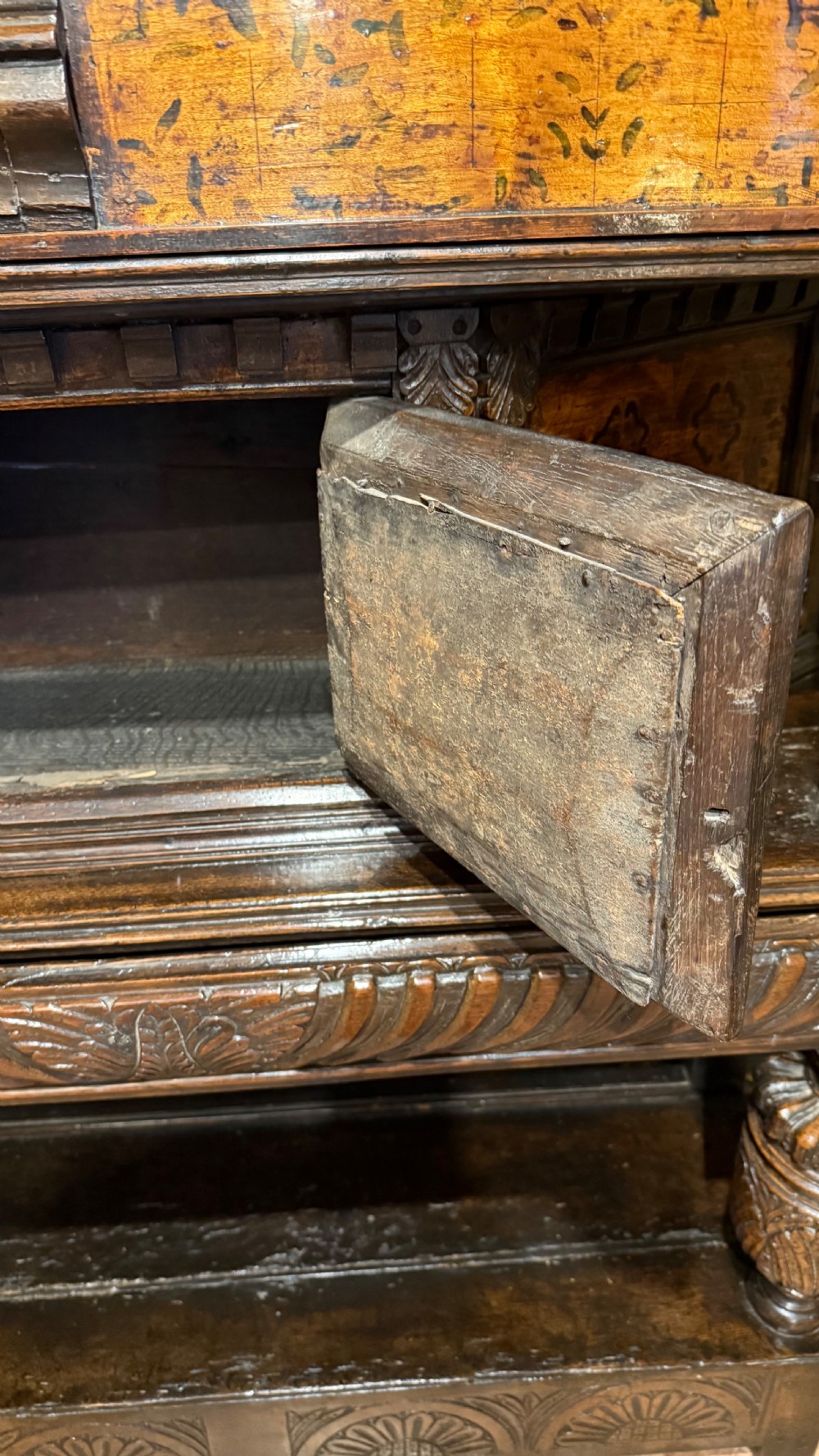 A 17th-century carved oak livery cupboard featuring inlaid wooden panels, carved lion supports, and bulbous turned legs. View XVII
