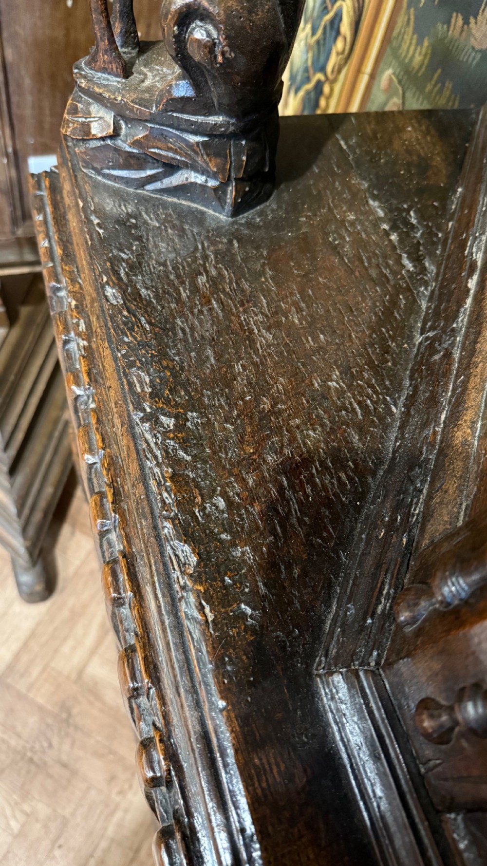 A 17th-century carved oak livery cupboard featuring inlaid wooden panels, carved lion supports, and bulbous turned legs. View XX