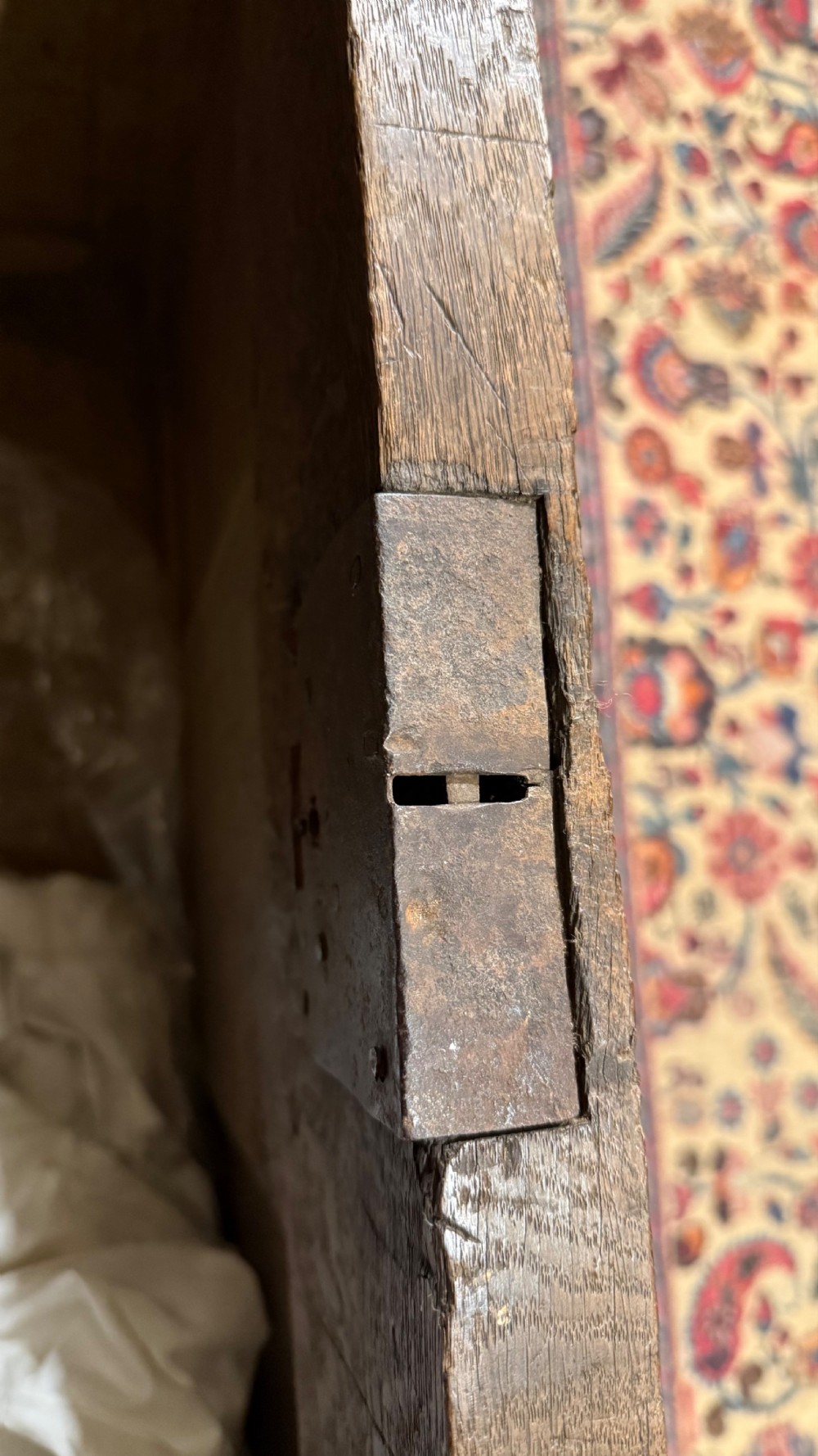 A 16th-century oak coffer featuring two carved Romayne head panels set within carved arches and a central keyhole escutcheon. View XX