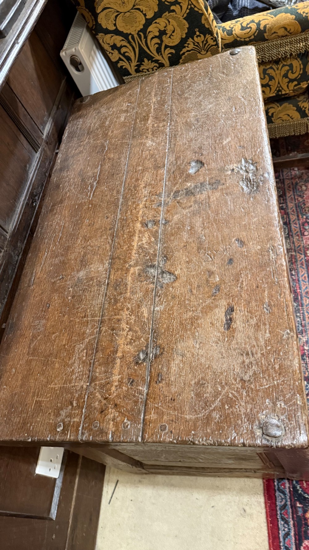 A 16th-century oak coffer featuring two carved Romayne head panels set within carved arches and a central keyhole escutcheon. View XXIII