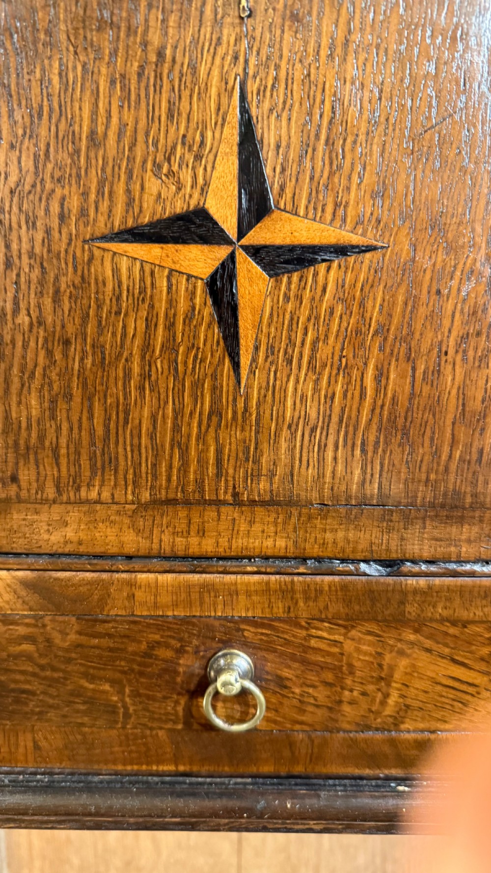 A 19th-century wall-mounted oak box featuring a star marquetry inlay, a heart-shaped hanging cut-out, and a lower drawer with a metal ring pull. View II