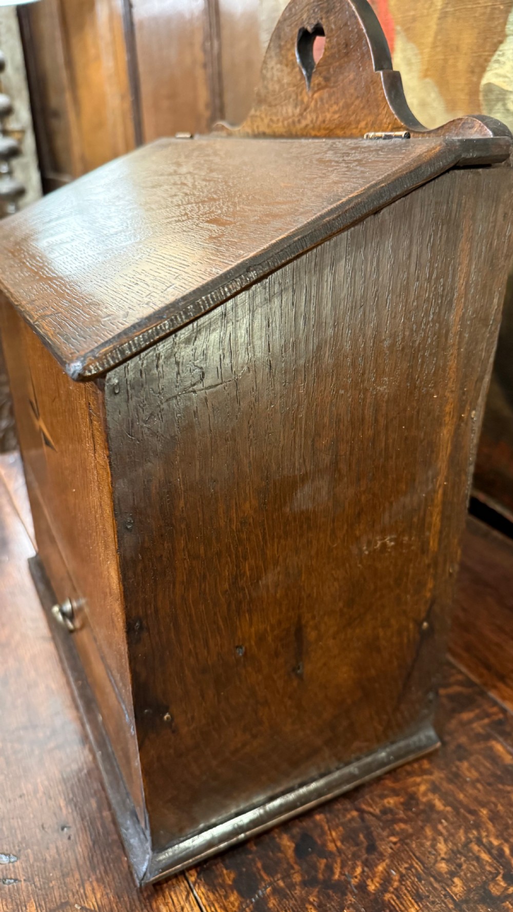 A 19th-century wall-mounted oak box featuring a star marquetry inlay, a heart-shaped hanging cut-out, and a lower drawer with a metal ring pull. View IX