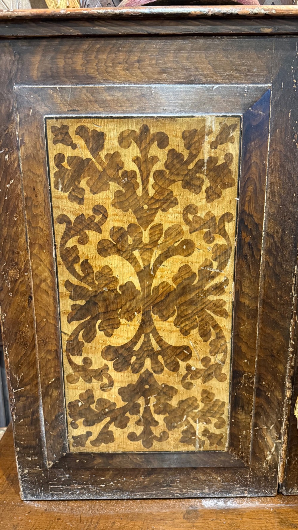 A nineteenth-century warm brown wooden tabletop collectors cabinet featuring intricate foliate marquetry inlay panels on the twin doors and top. View XXII