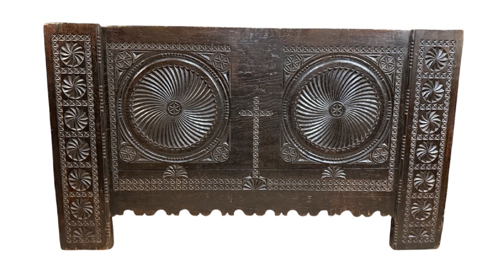 A 16th-century carved dark oak coffer front panel featuring central cross and circular pinwheel motifs with geometric borders. View III