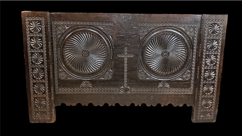 A 16th-century carved dark oak coffer front panel featuring central cross and circular pinwheel motifs with geometric borders. View IV