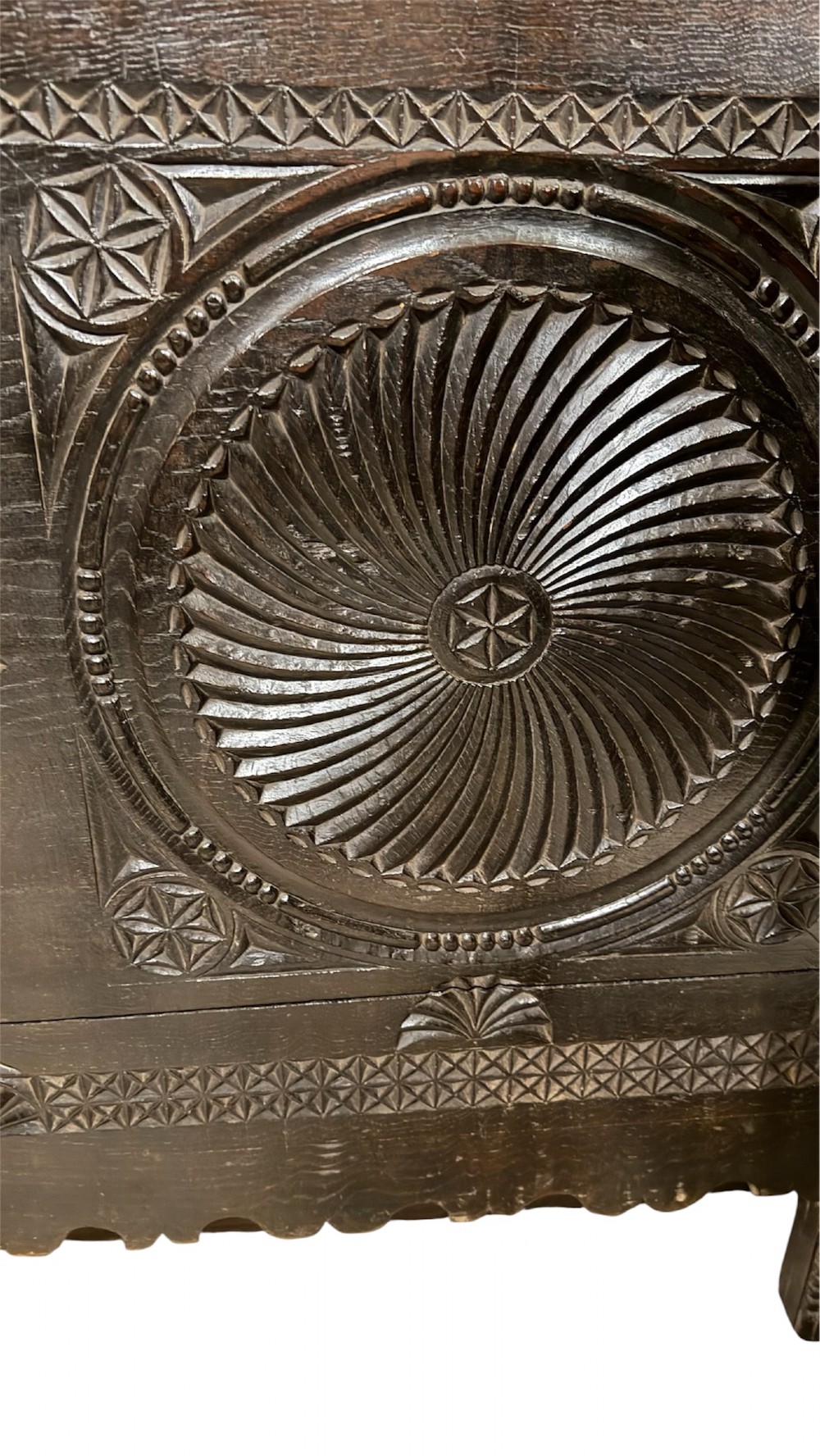 A 16th-century carved dark oak coffer front panel featuring central cross and circular pinwheel motifs with geometric borders. View XV