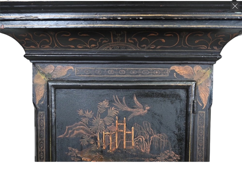 An 18th-century black japanned longcase clock decorated with gold chinoiserie scenes and featuring an arched brass dial. View IX