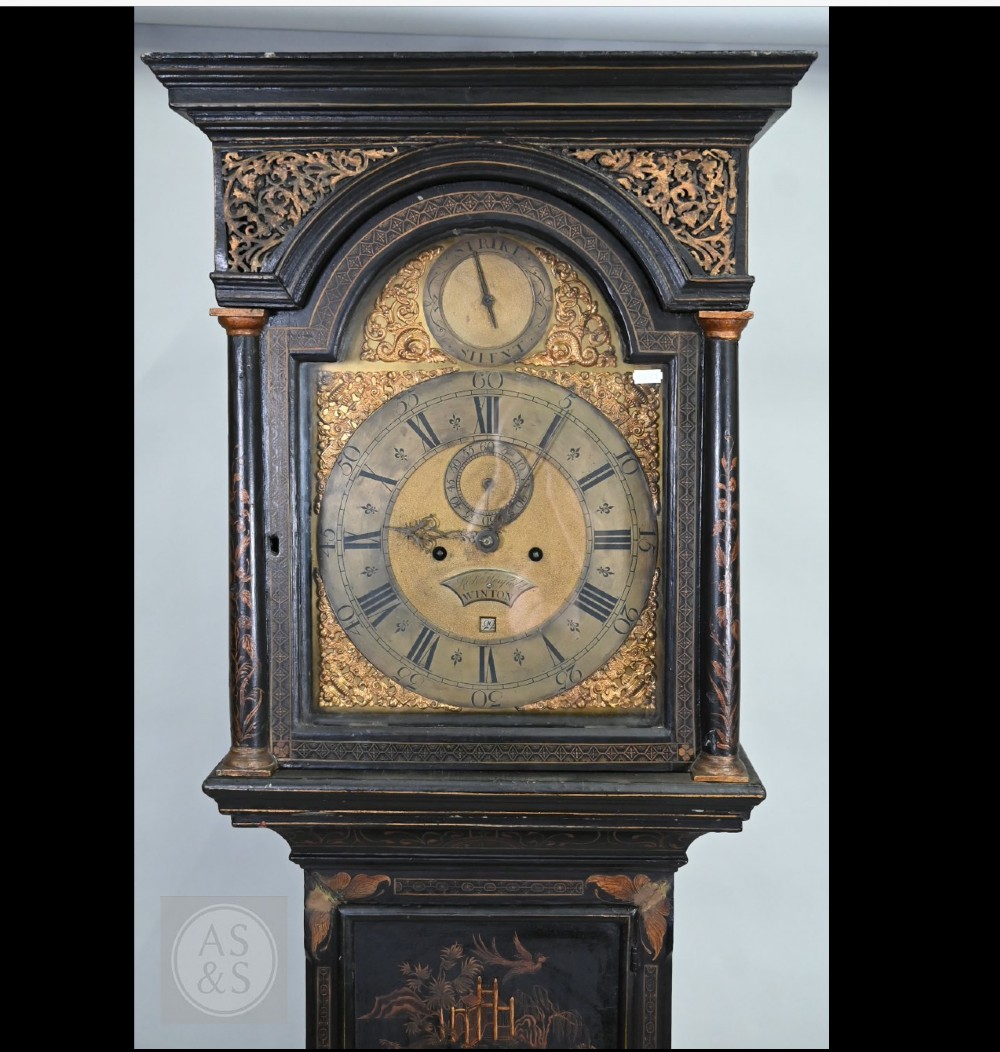 An 18th-century black japanned longcase clock decorated with gold chinoiserie scenes and featuring an arched brass dial. View XI