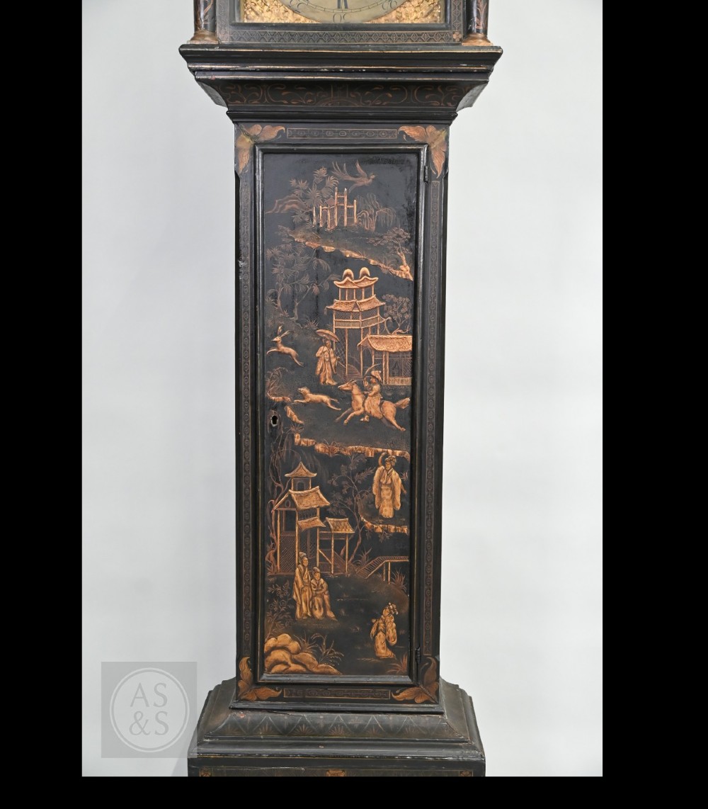 An 18th-century black japanned longcase clock decorated with gold chinoiserie scenes and featuring an arched brass dial. View XV