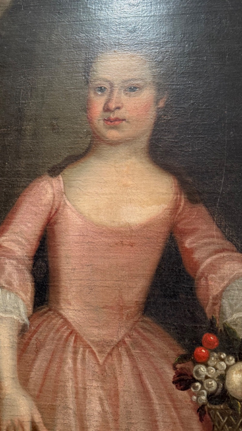 An eighteenth-century oil painting of a young girl in a pink dress holding a floral wreath, set alongside a lamb within an elaborate gold gilt frame. View IX