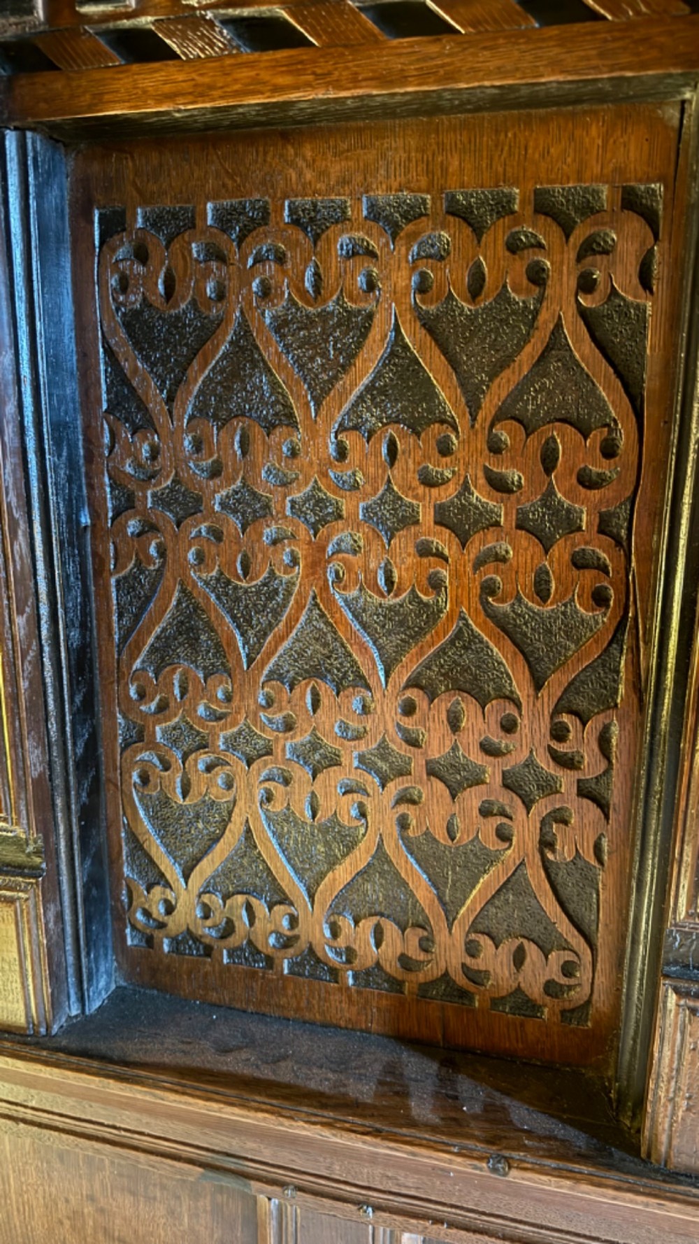 A 17th-century English oak tester bed featuring a heavy panelled canopy, carved geometric headboard, and turned wooden posts. View VII