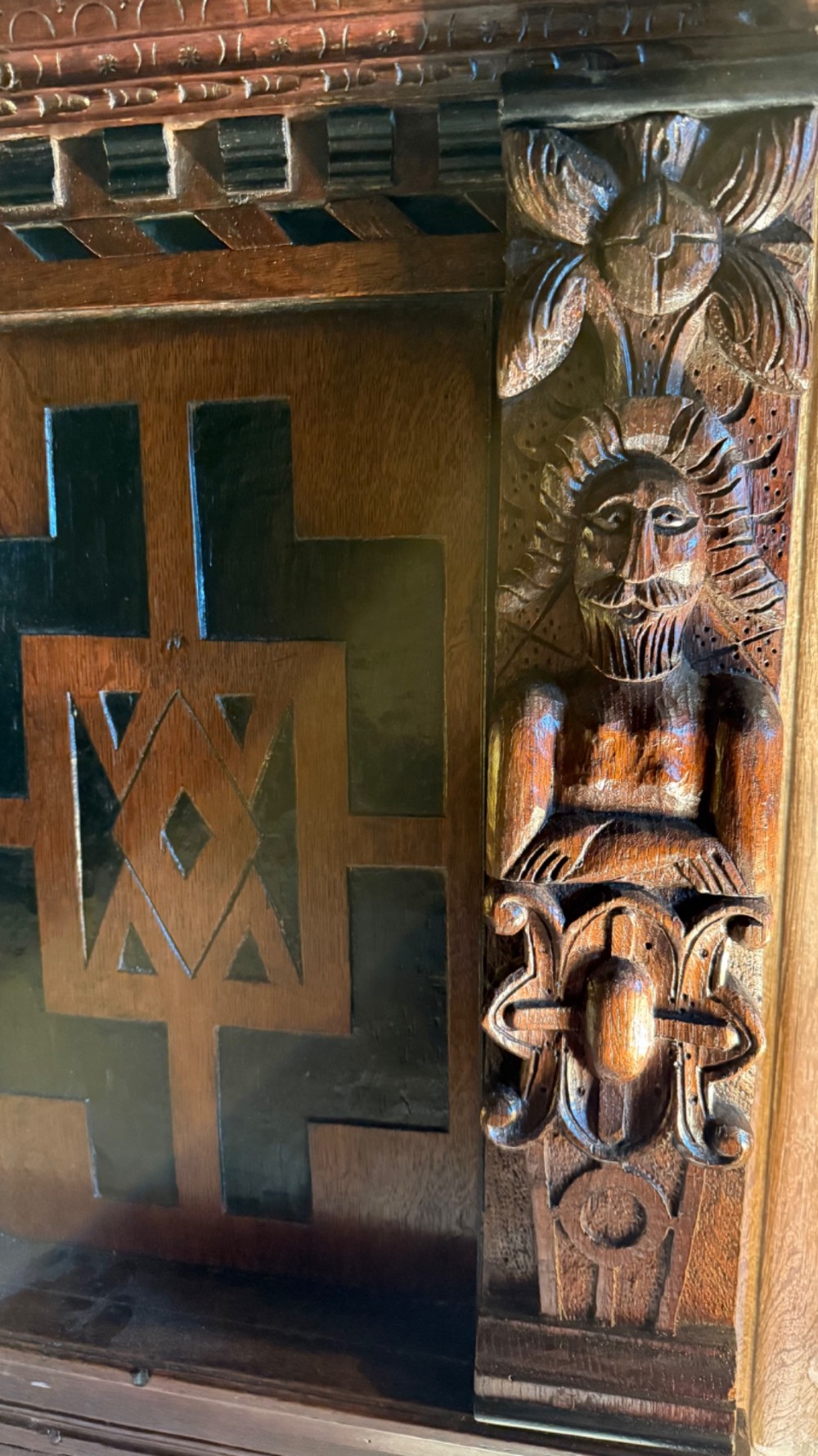 A 17th-century English oak tester bed featuring a heavy panelled canopy, carved geometric headboard, and turned wooden posts. View VIII