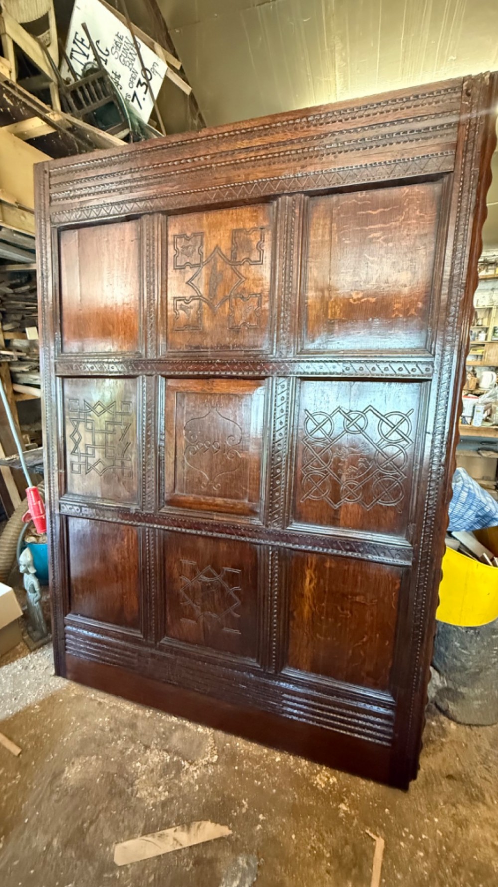 A 17th-century English oak tester bed featuring a heavy panelled canopy, carved geometric headboard, and turned wooden posts. View XV