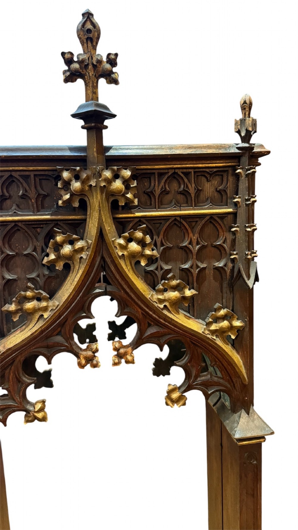 A dark carved oak Gothic Revival mirror frame featuring a pointed arch, intricate tracery, gilded crockets, and decorative finials. View III