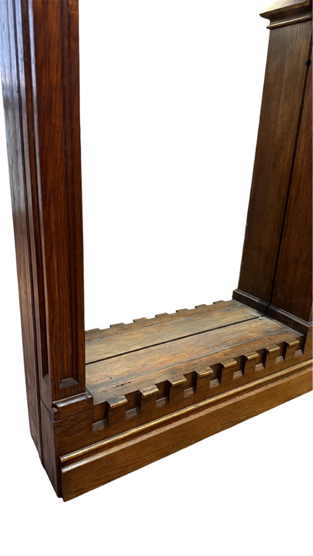 A dark carved oak Gothic Revival mirror frame featuring a pointed arch, intricate tracery, gilded crockets, and decorative finials. View VIII
