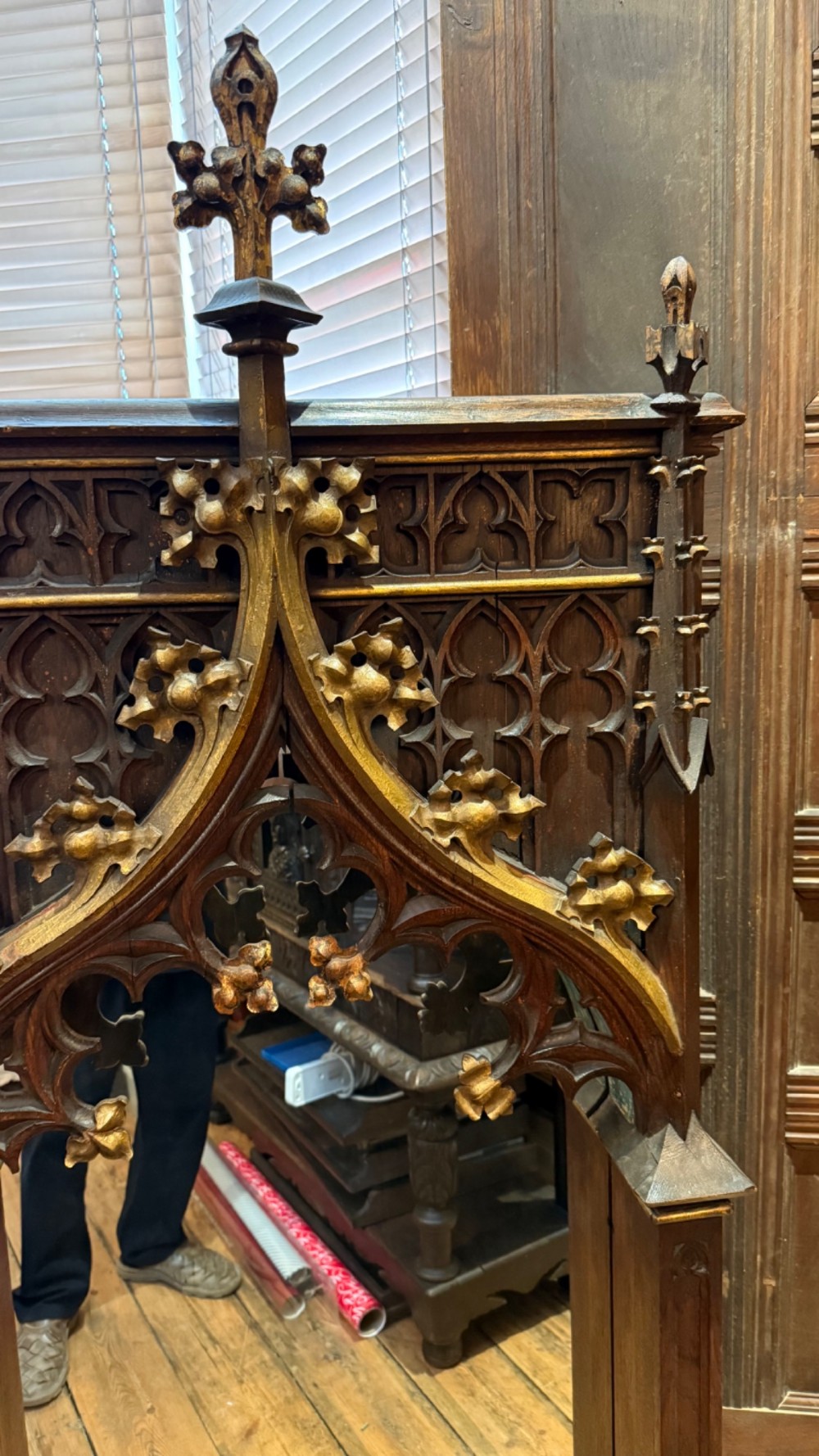 A dark carved oak Gothic Revival mirror frame featuring a pointed arch, intricate tracery, gilded crockets, and decorative finials. View XIII
