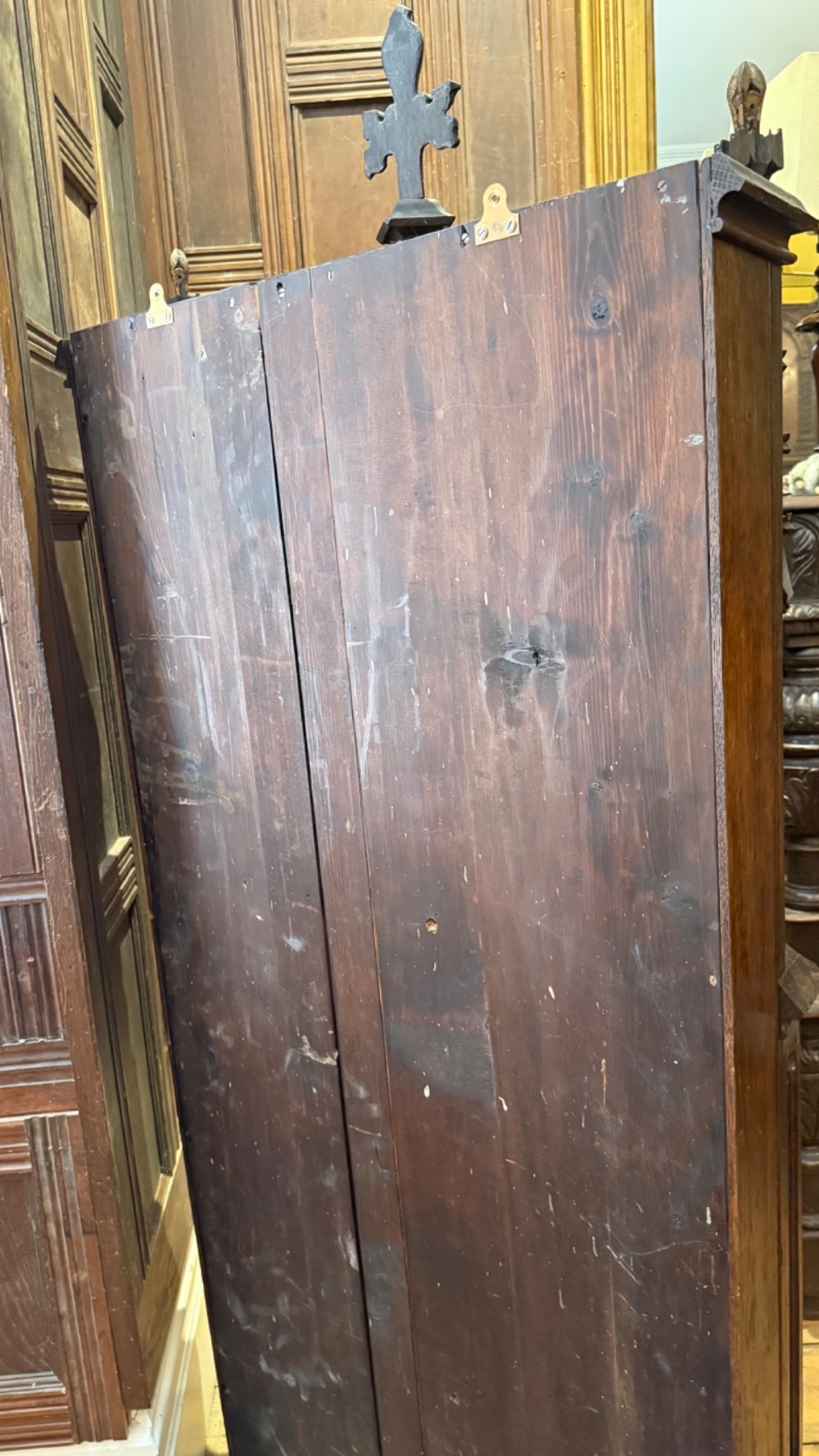 A dark carved oak Gothic Revival mirror frame featuring a pointed arch, intricate tracery, gilded crockets, and decorative finials. View XV