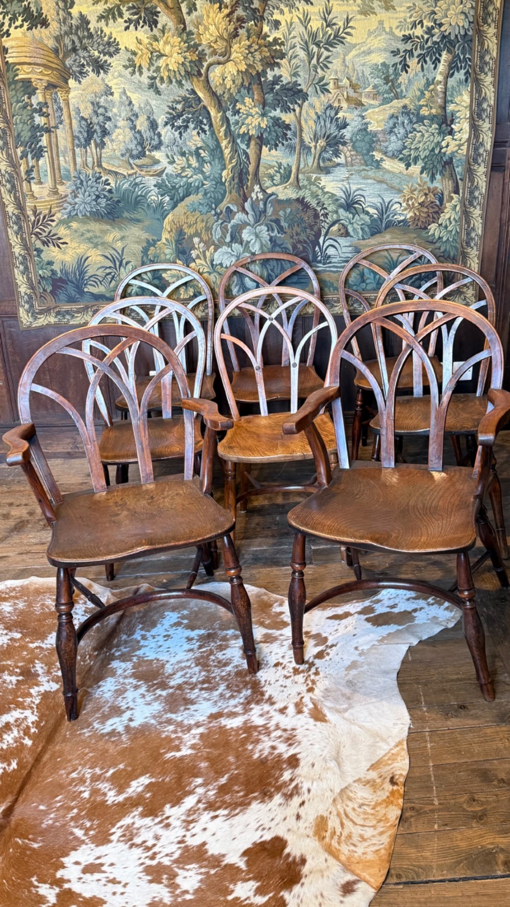 A set of 19th-century Gothic Windsor wooden dining chairs featuring pointed arch back splats, saddle seats, and turned legs. View II