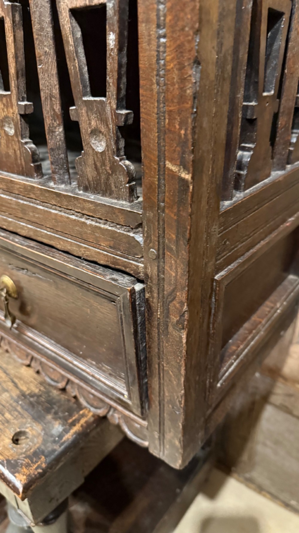 A dark oak seventeenth-century hanging cupboard featuring two upper tiers with carved pierced balusters and three small drawers with teardrop handles along the base. View IV
