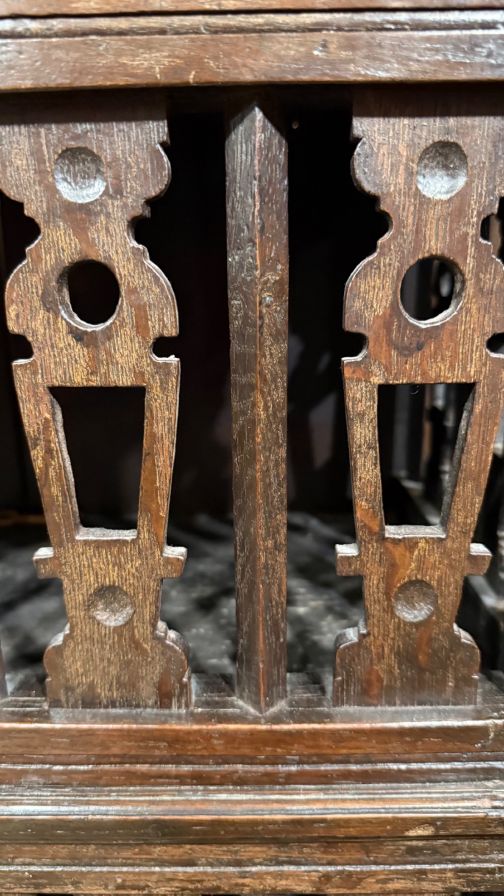 A dark oak seventeenth-century hanging cupboard featuring two upper tiers with carved pierced balusters and three small drawers with teardrop handles along the base. View XIII
