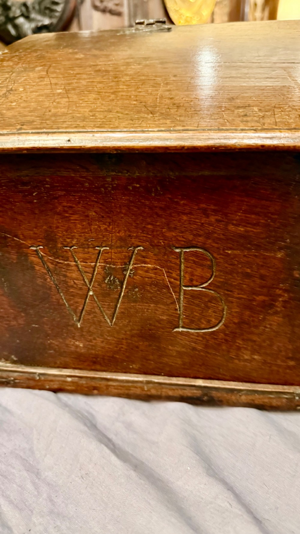 An 18th-century oak Bible box featuring a sloped hinged lid, incised initials WB, the date 1733, and a central iron lock plate. View II