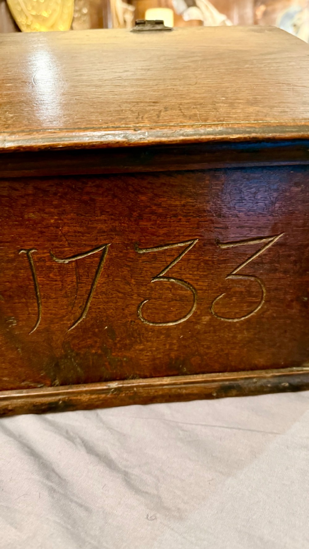 An 18th-century oak Bible box featuring a sloped hinged lid, incised initials WB, the date 1733, and a central iron lock plate. View III