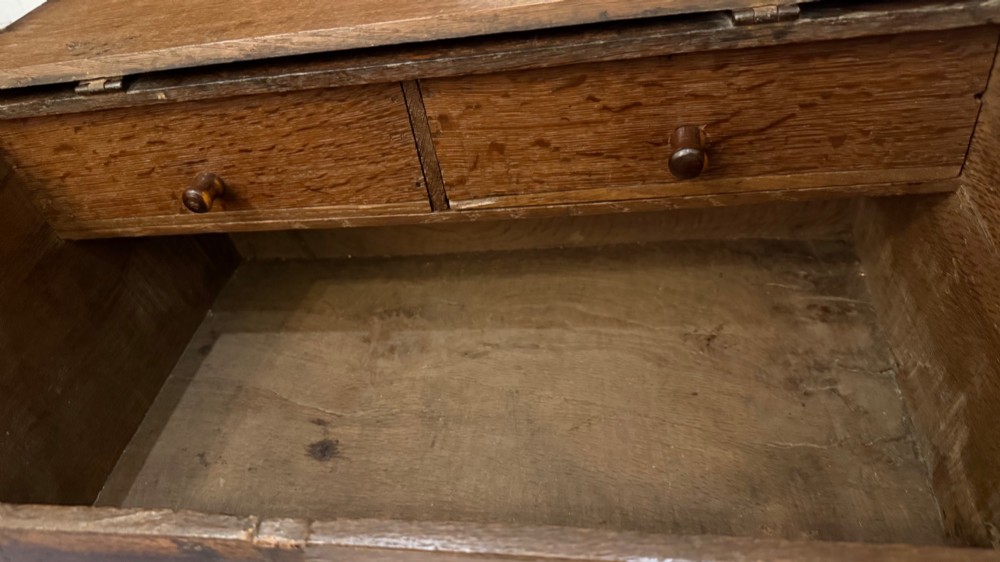 An 18th-century oak Bible box featuring a sloped hinged lid, incised initials WB, the date 1733, and a central iron lock plate. View X