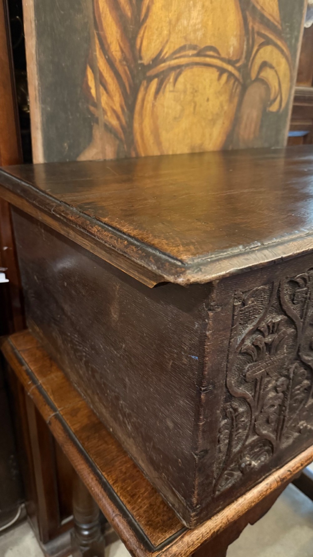 A 17th-century English oak bible box featuring relief carvings of foliate patterns across the front panel and a central iron lock plate. View VII