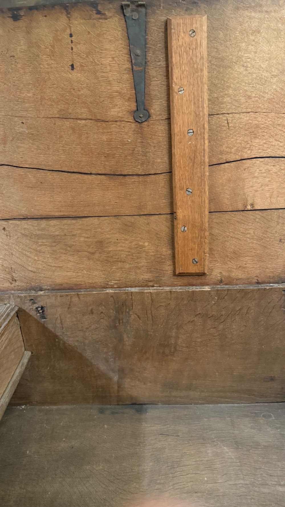 A 17th-century English oak bible box featuring relief carvings of foliate patterns across the front panel and a central iron lock plate. View XIII