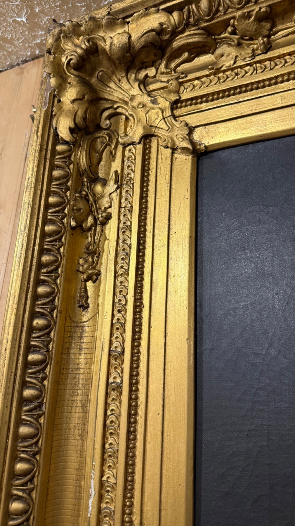 A nineteenth-century oil portrait of a draped woman holding a small lamp, housed within an ornate gilded frame. View VII