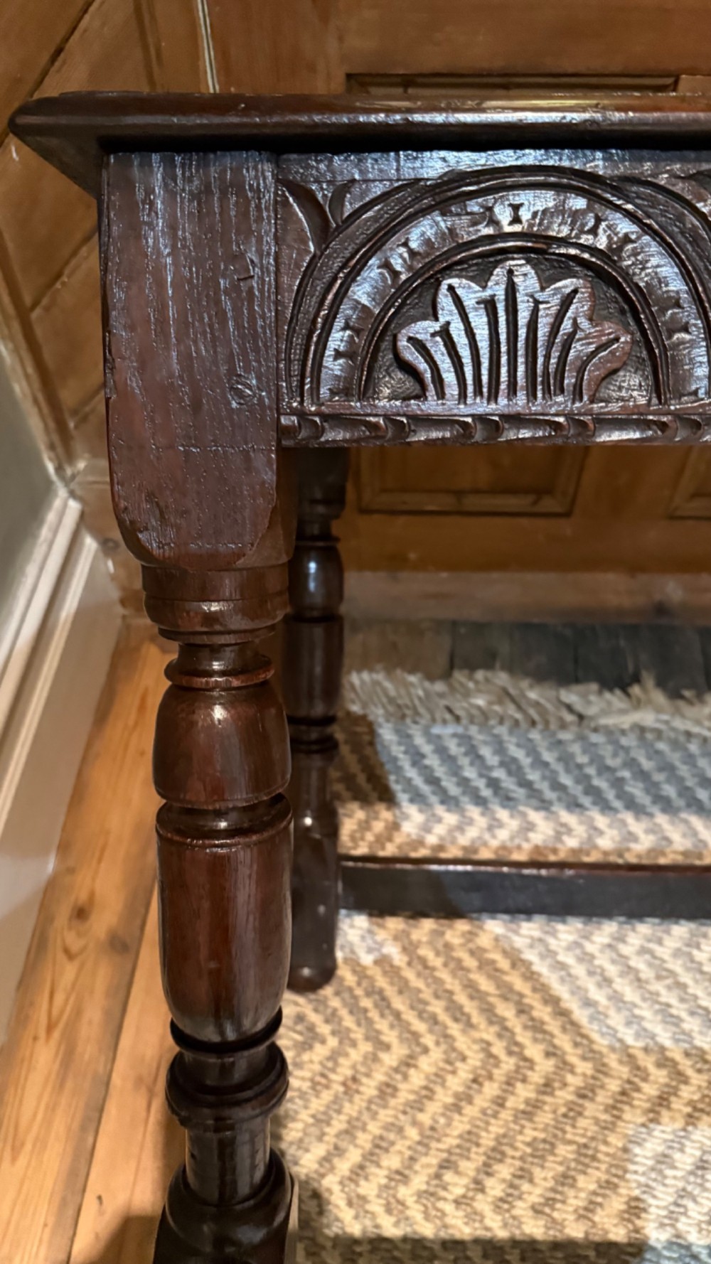 A dark oak 17th-century centre table featuring a carved fan-pattern apron, turned baluster legs, and sturdy wooden stretchers. View III