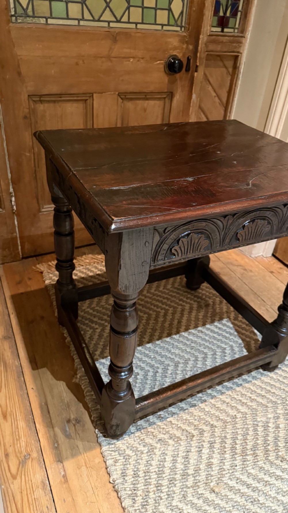 A dark oak 17th-century centre table featuring a carved fan-pattern apron, turned baluster legs, and sturdy wooden stretchers. View IV